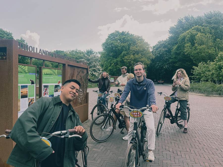 Kolleger på lånecykler ved indgangen til et hollandsk naturreservat.
